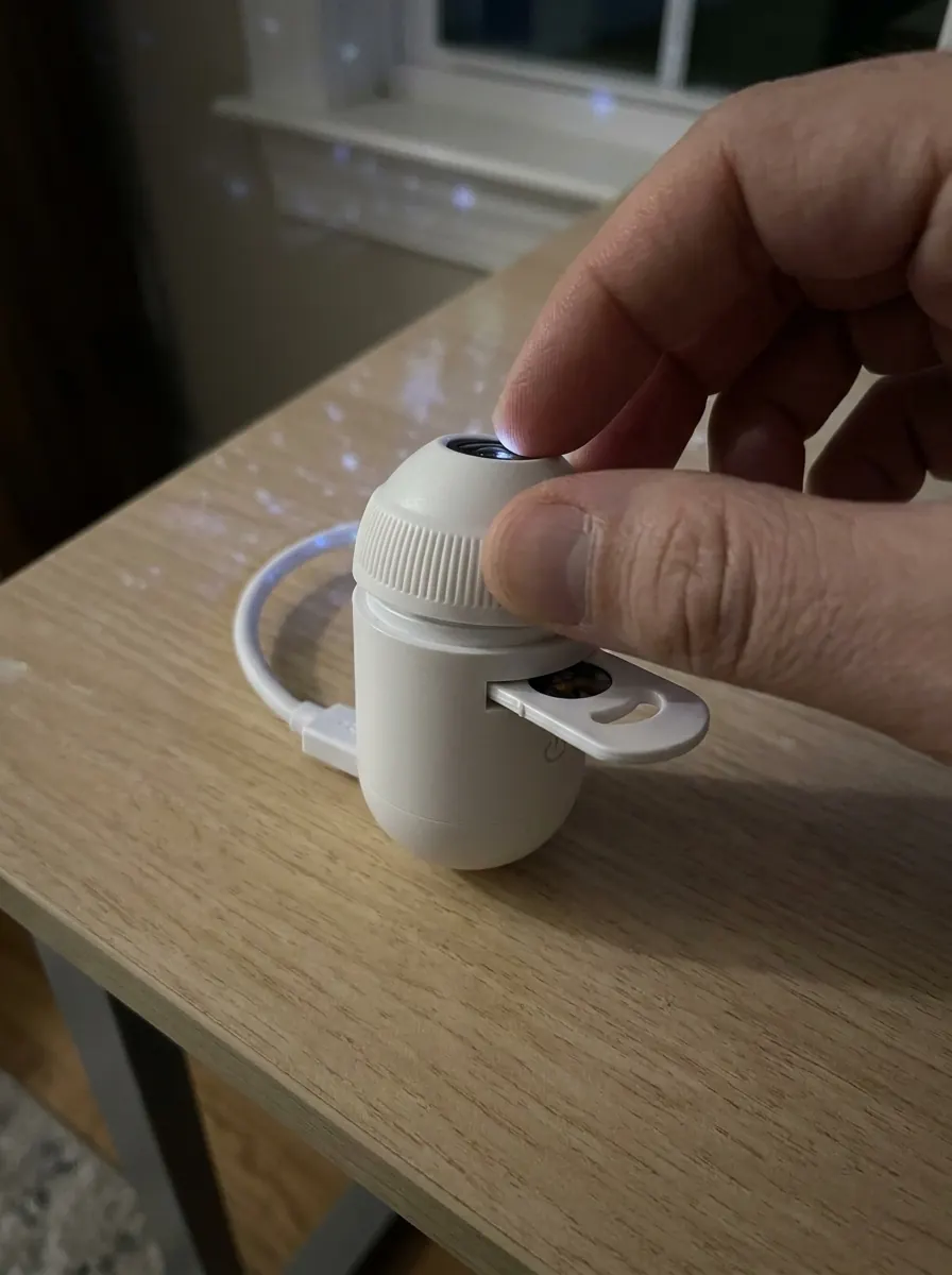 Render of fingers twisting the top ring of SkyPlug to focus the projection.