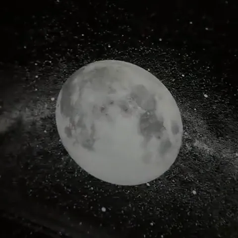 Still from the seller's video: a full Moon with craters projected on a dark ceiling over a band of stars.